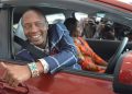 President Uhuru Kenyatta's look alike, Uhunye showing off the car he received from Maridady Motors